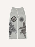 Pantalones con cintura elástica y estampado de ojos, alas y sol